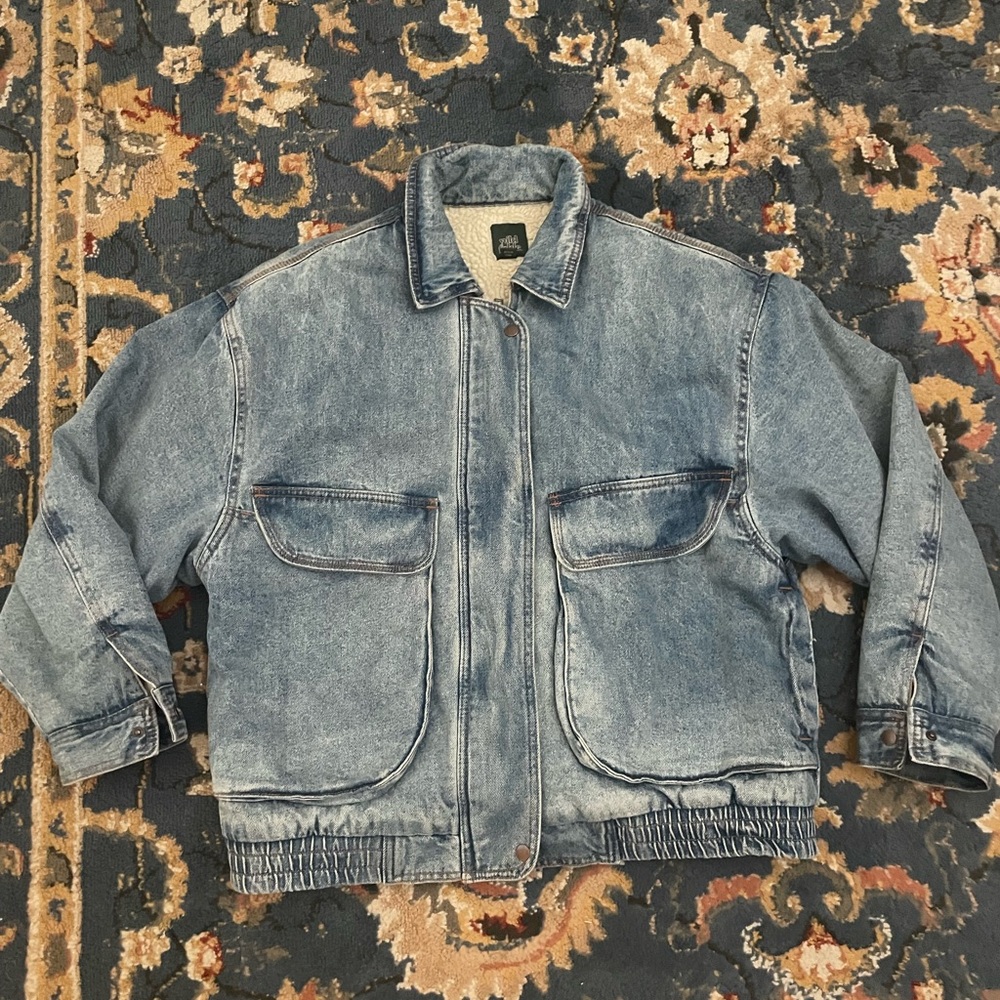 Light wash jean jacket. Has big cargo like pockets.
